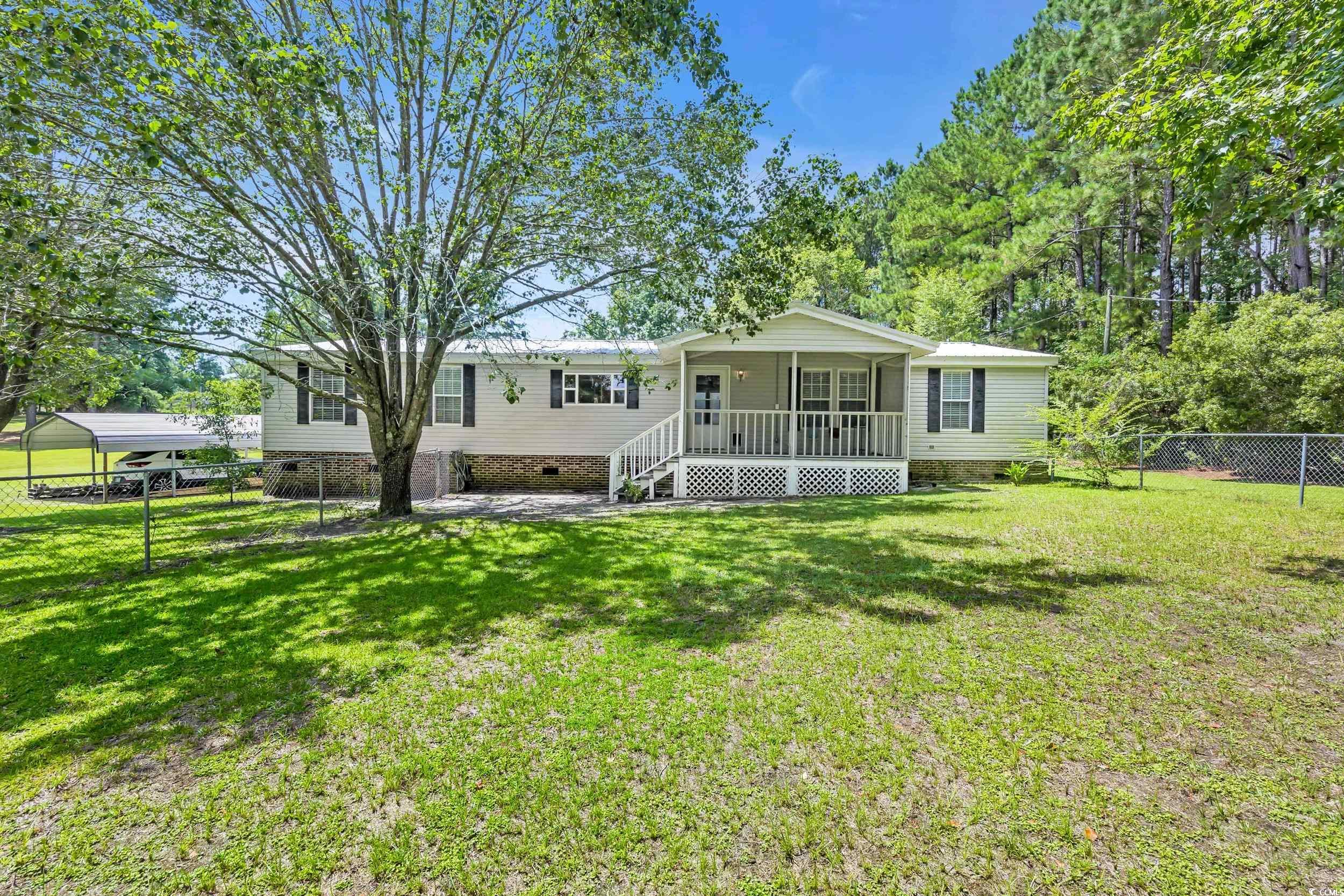 3373 Lake Pond Road Loris, SC 29569 - Photo 1 of 33 View of front of property featuring crawl space, a porch, and a fenced backyard