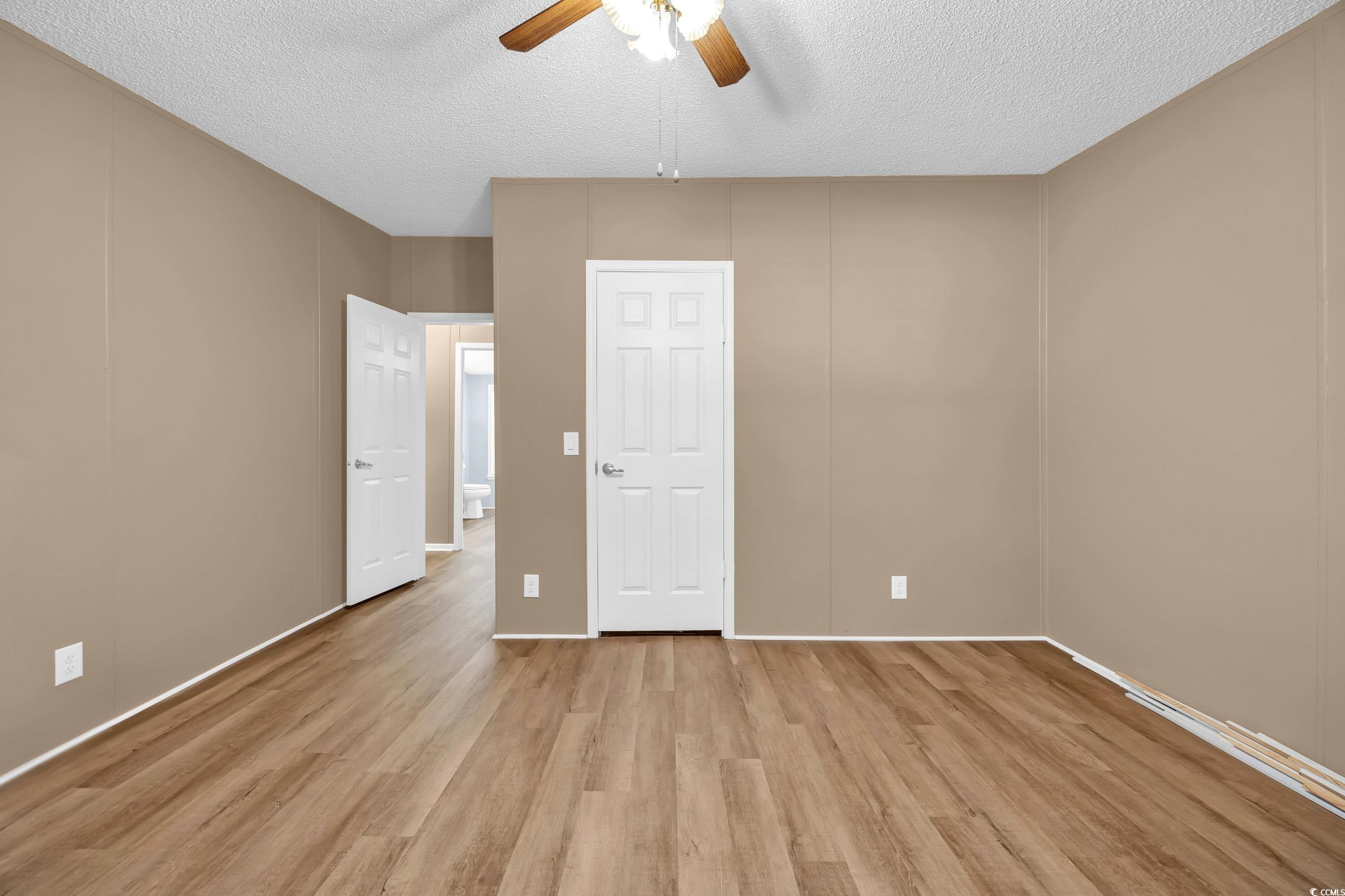 3373 Lake Pond Road Loris, SC 29569 - Photo 15 of 33 Unfurnished bedroom with a textured ceiling, light wood-style flooring, and a ceiling fan