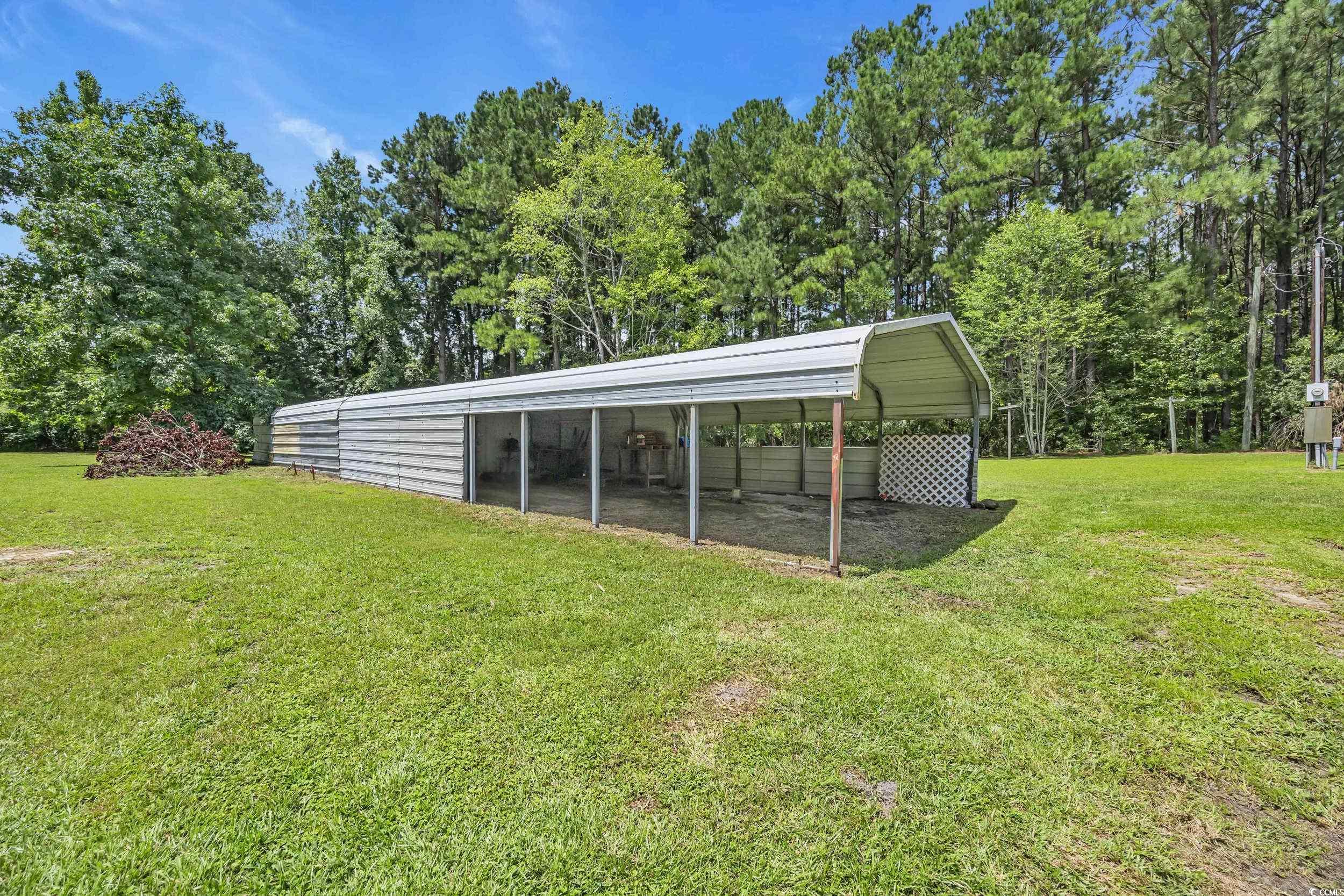 3373 Lake Pond Road Loris, SC 29569 - Photo 23 of 33 View of green lawn featuring a detached carport