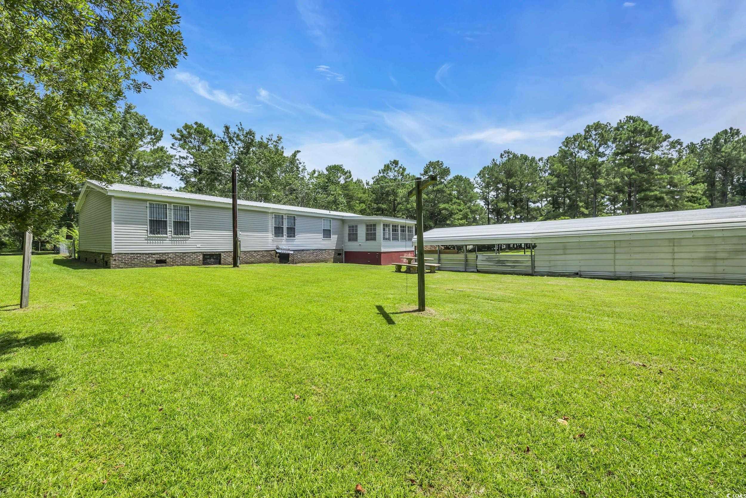 3373 Lake Pond Road Loris, SC 29569 - Photo 24 of 33 View of grassy yard featuring view of wooded area