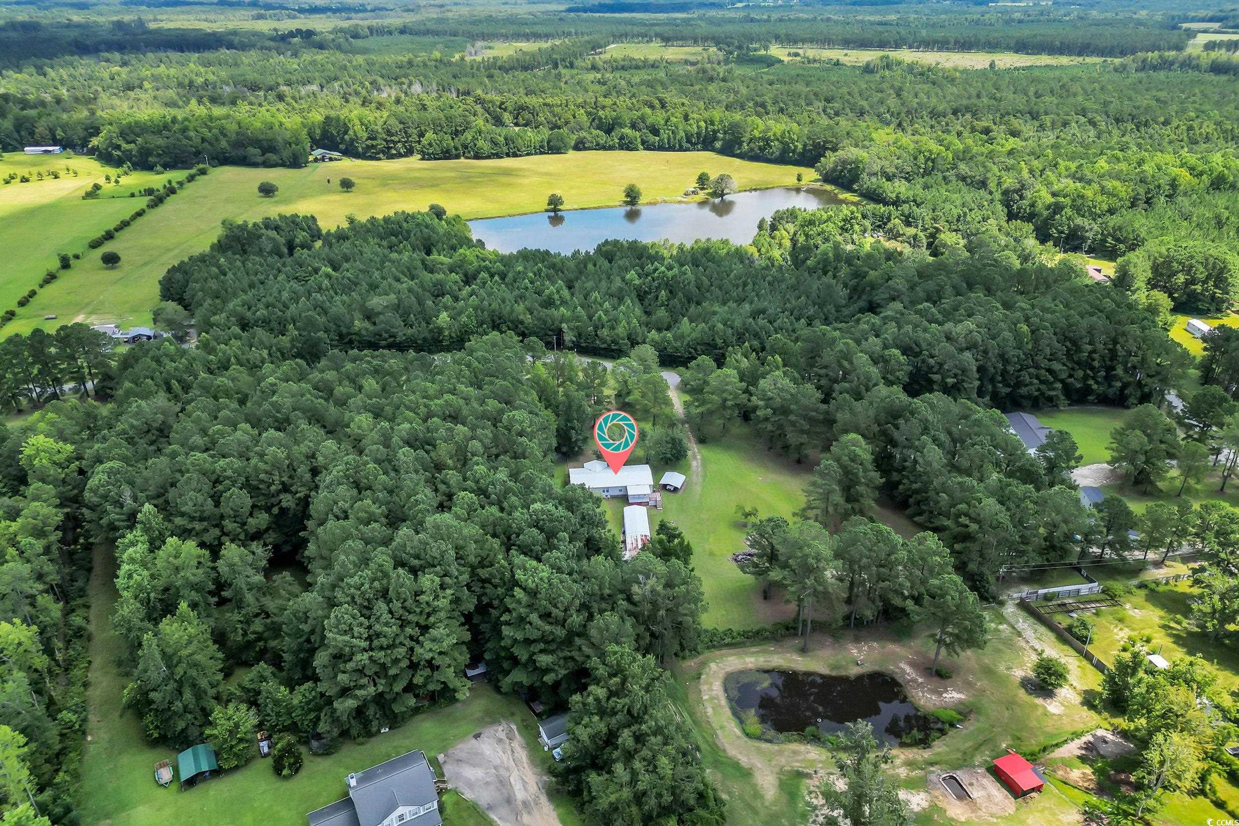 3373 Lake Pond Road Loris, SC 29569 - Photo 28 of 33 Aerial overview of property's location featuring a large body of water and a forest