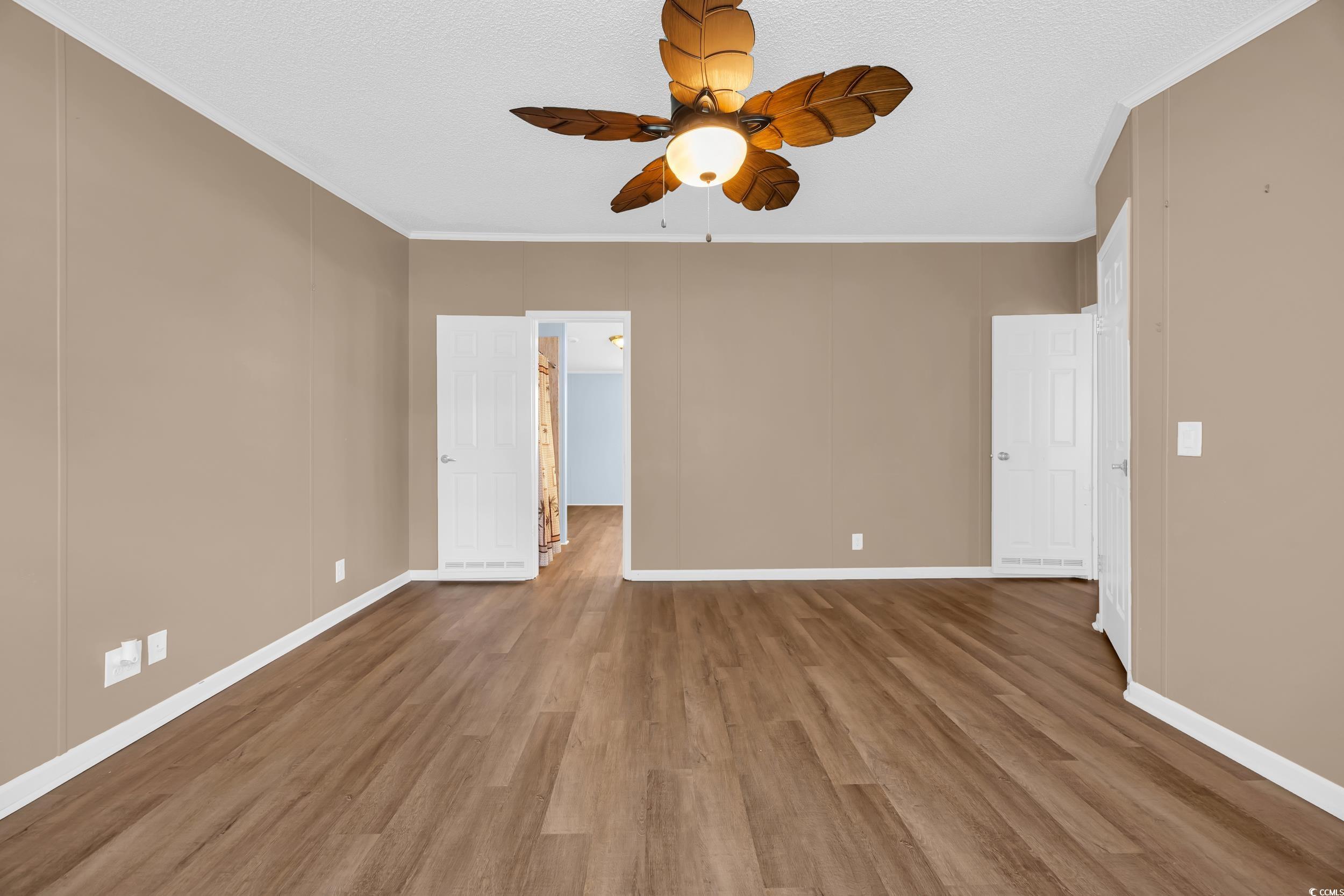 3373 Lake Pond Road Loris, SC 29569 - Photo 7 of 33 Spare room featuring a ceiling fan, crown molding, wood finished floors, and a textured ceiling