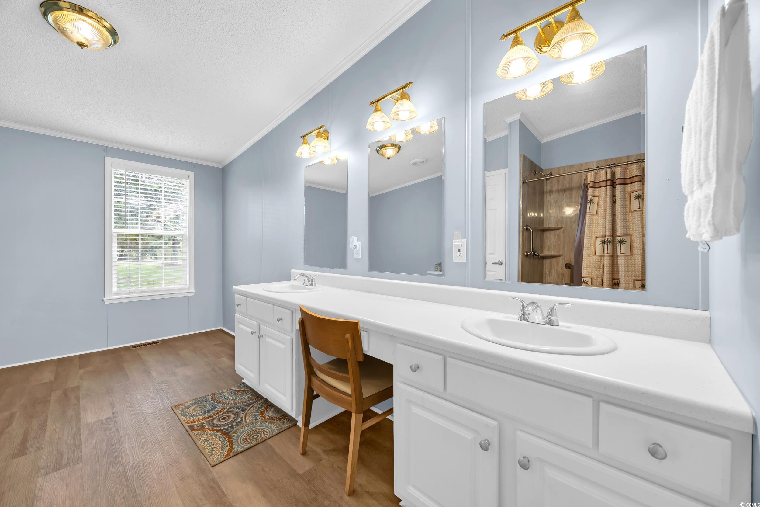 3373 Lake Pond Road Loris, SC 29569 - Photo 8 of 33 Bathroom featuring double vanity, ornamental molding, wood finished floors, curtained shower, and vaulted ceiling
