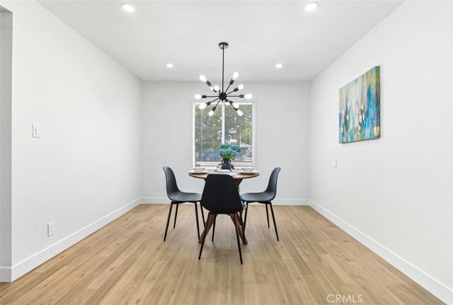 a dining room with furniture and wooden floor