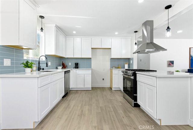 a kitchen with a white cabinets stove top oven and refrigerator