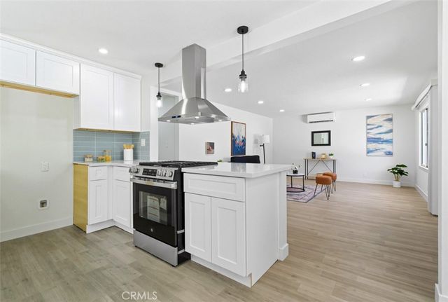 a kitchen with a stove a sink and a refrigerator