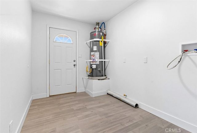 a view of a storage & utility room with a window