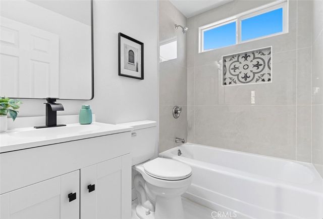 a bathroom with a toilet a sink and a bathtub