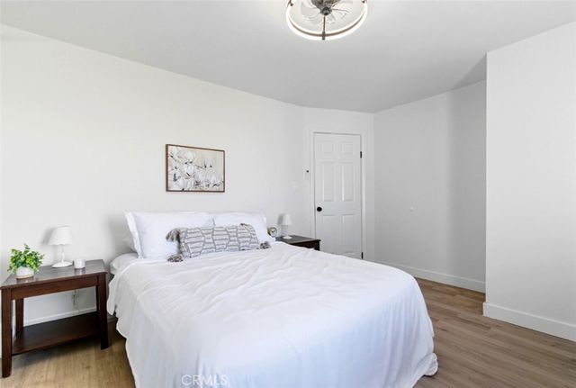 a bedroom with a bed and a potted plant