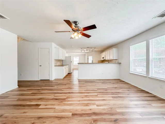 a view of a kitchen with microwave and windows