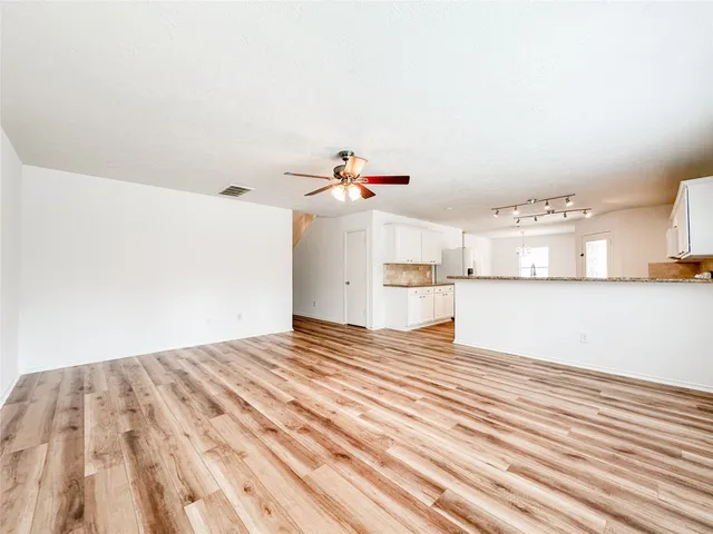 a view of a room with a dishwasher and cabinets