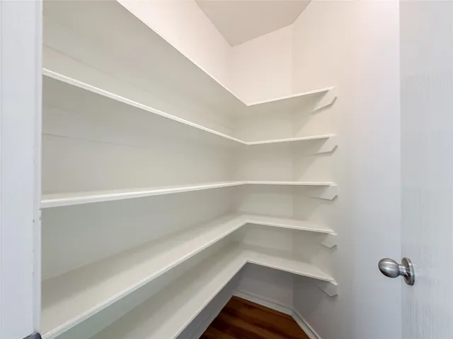 a view of walk in closet with empty racks