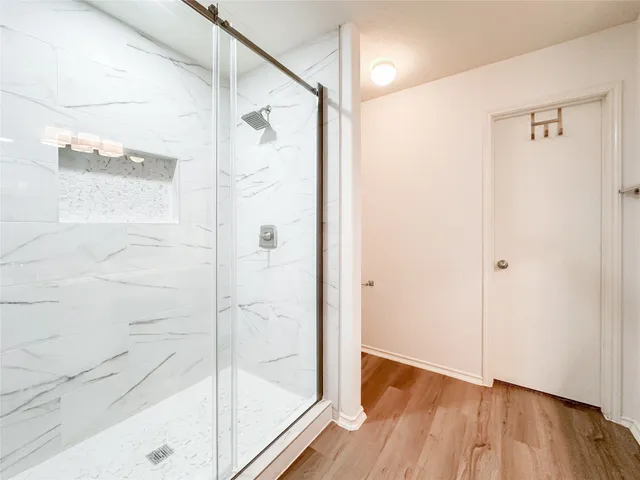 a bathroom with a glass shower door