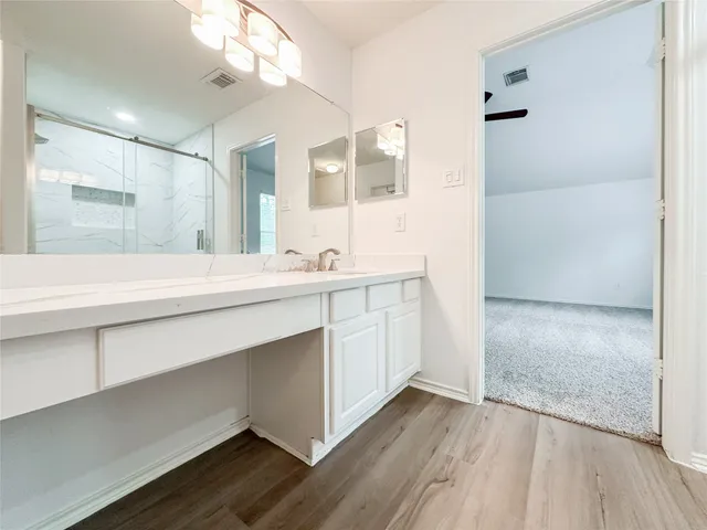 a bathroom with a sink a mirror and a shower