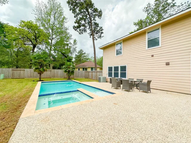 a view of a house with swimming pool and sitting area