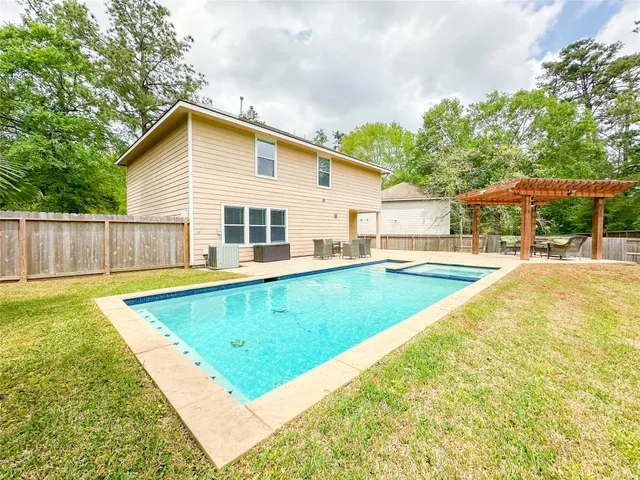 a view of a house with swimming pool and sitting area