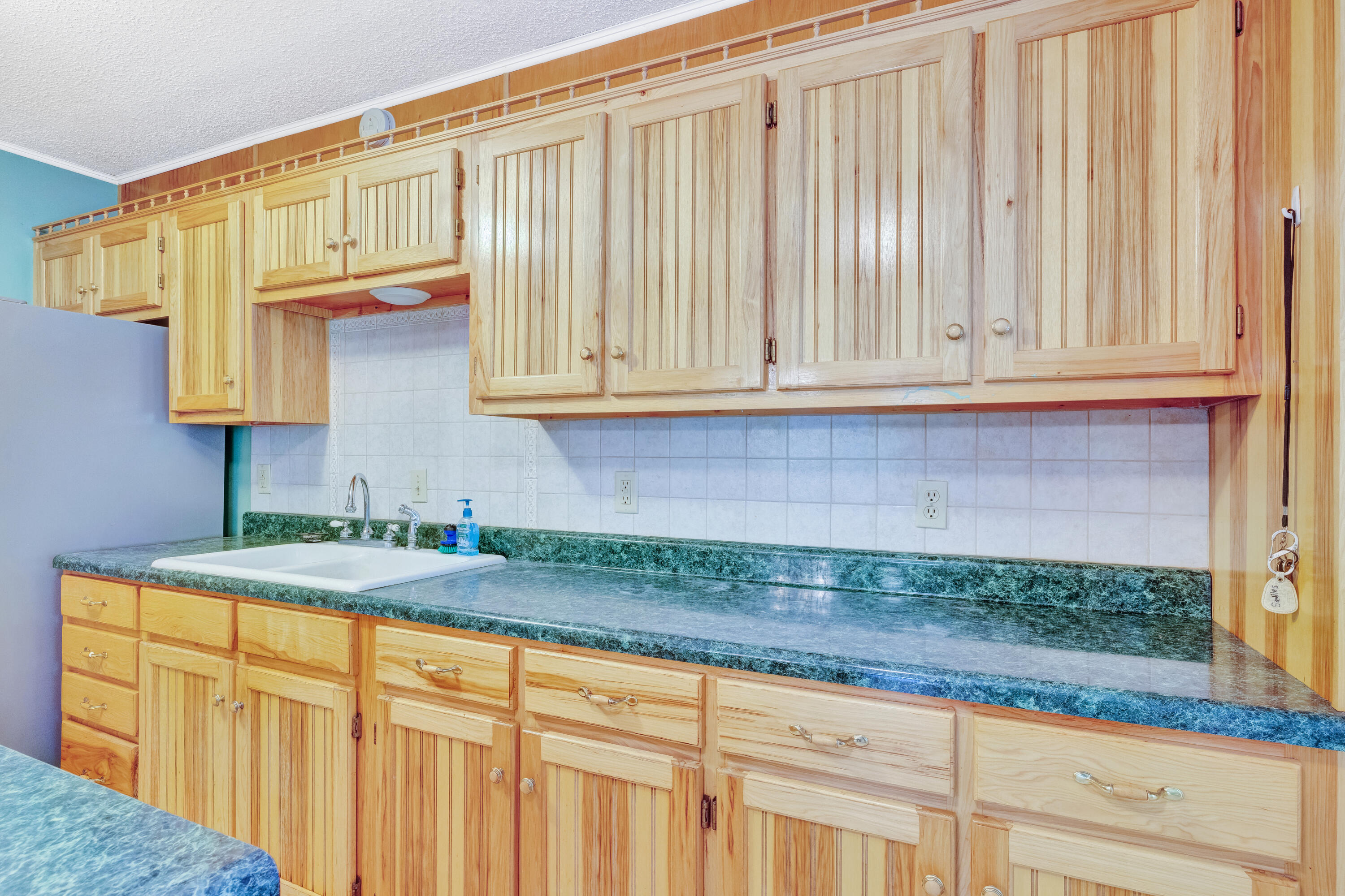 2540 Taylor Road Crestview, FL 32536 - Photo 16 of 75 a kitchen with granite countertop white cabinets and a wooden floor