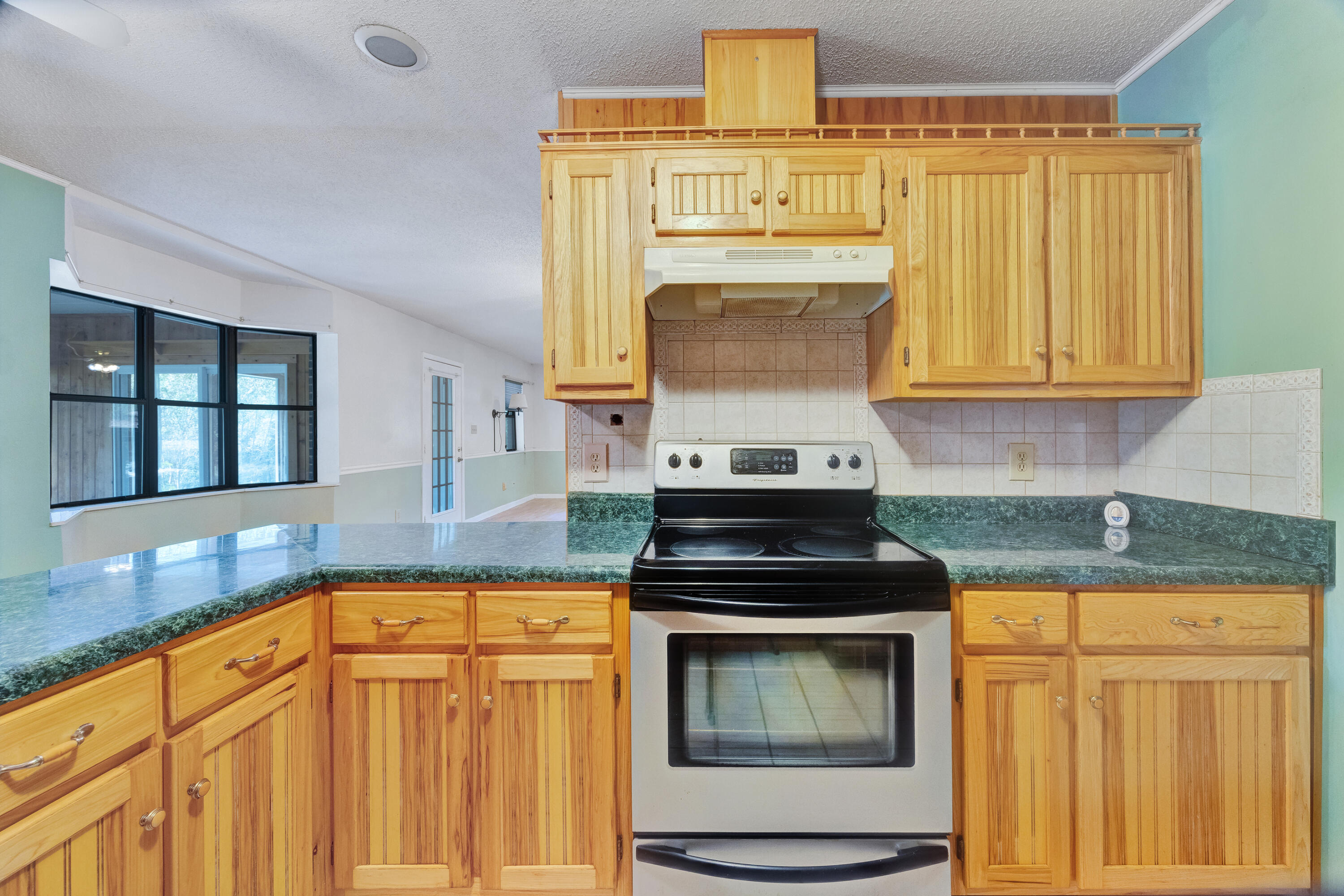 2540 Taylor Road Crestview, FL 32536 - Photo 18 of 75 a kitchen with a stove window and cabinets