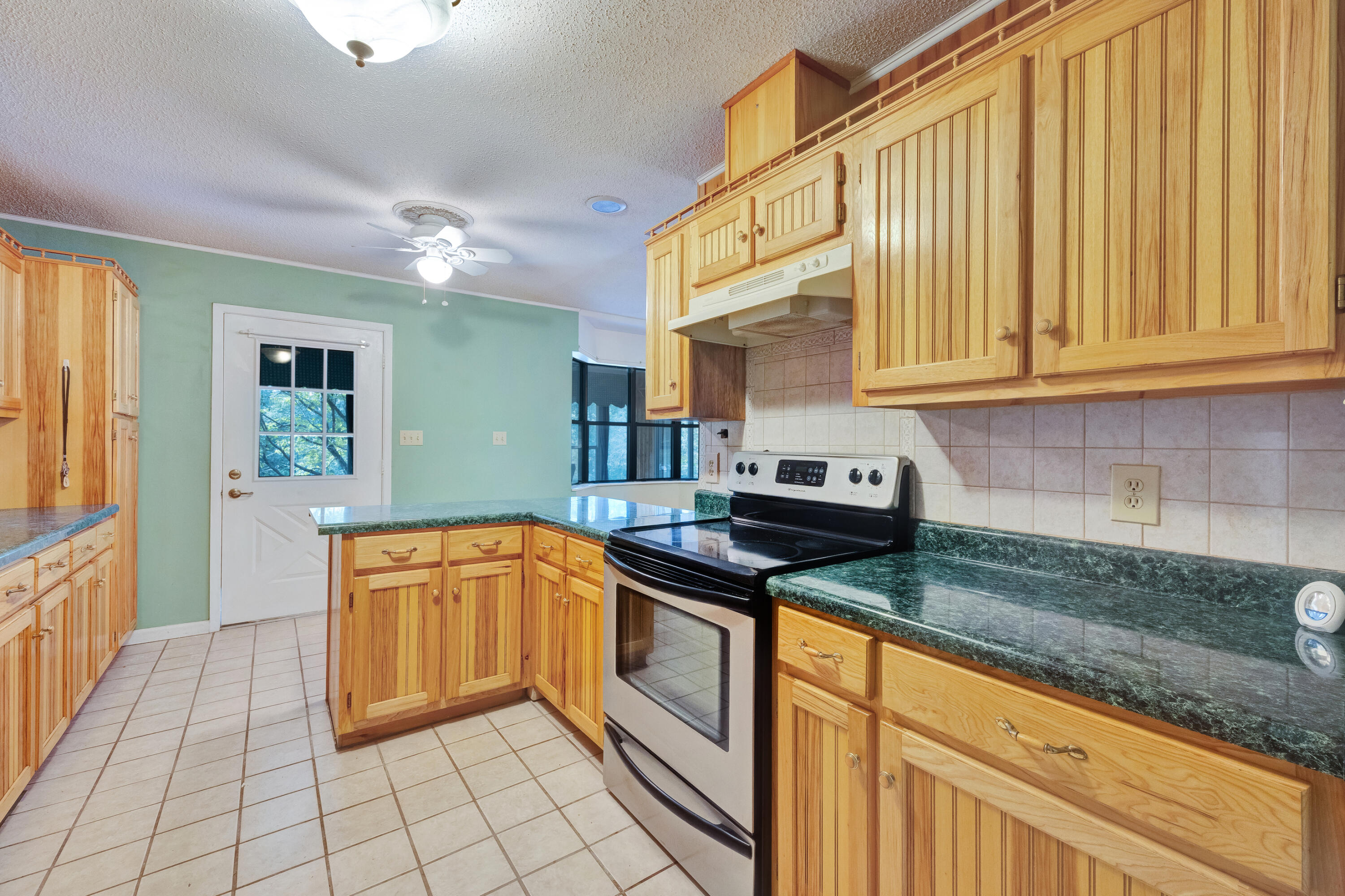 2540 Taylor Road Crestview, FL 32536 - Photo 19 of 75 a kitchen with granite countertop a sink and cabinets