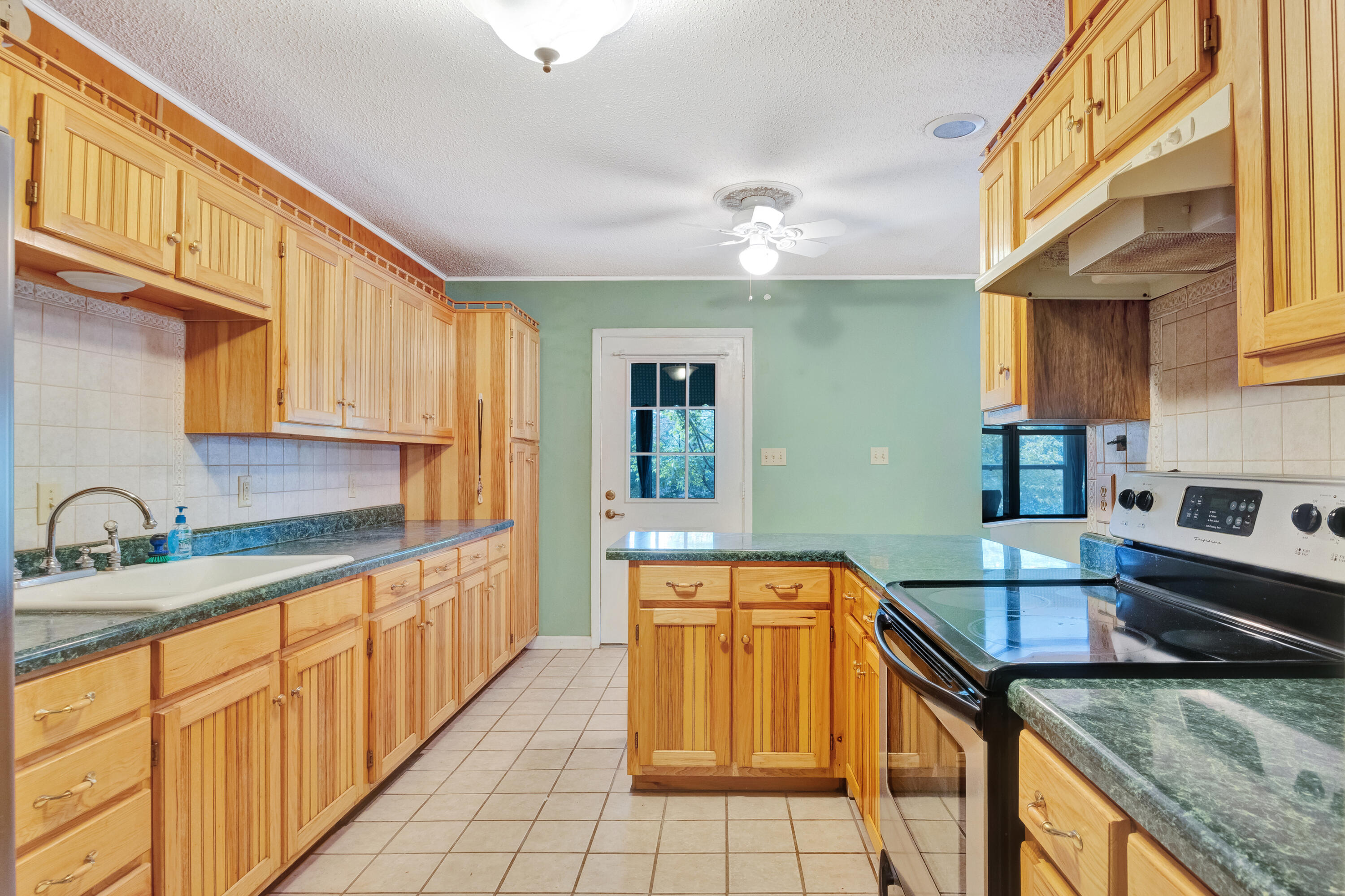 2540 Taylor Road Crestview, FL 32536 - Photo 20 of 75 a kitchen with stainless steel appliances granite countertop a sink and cabinets