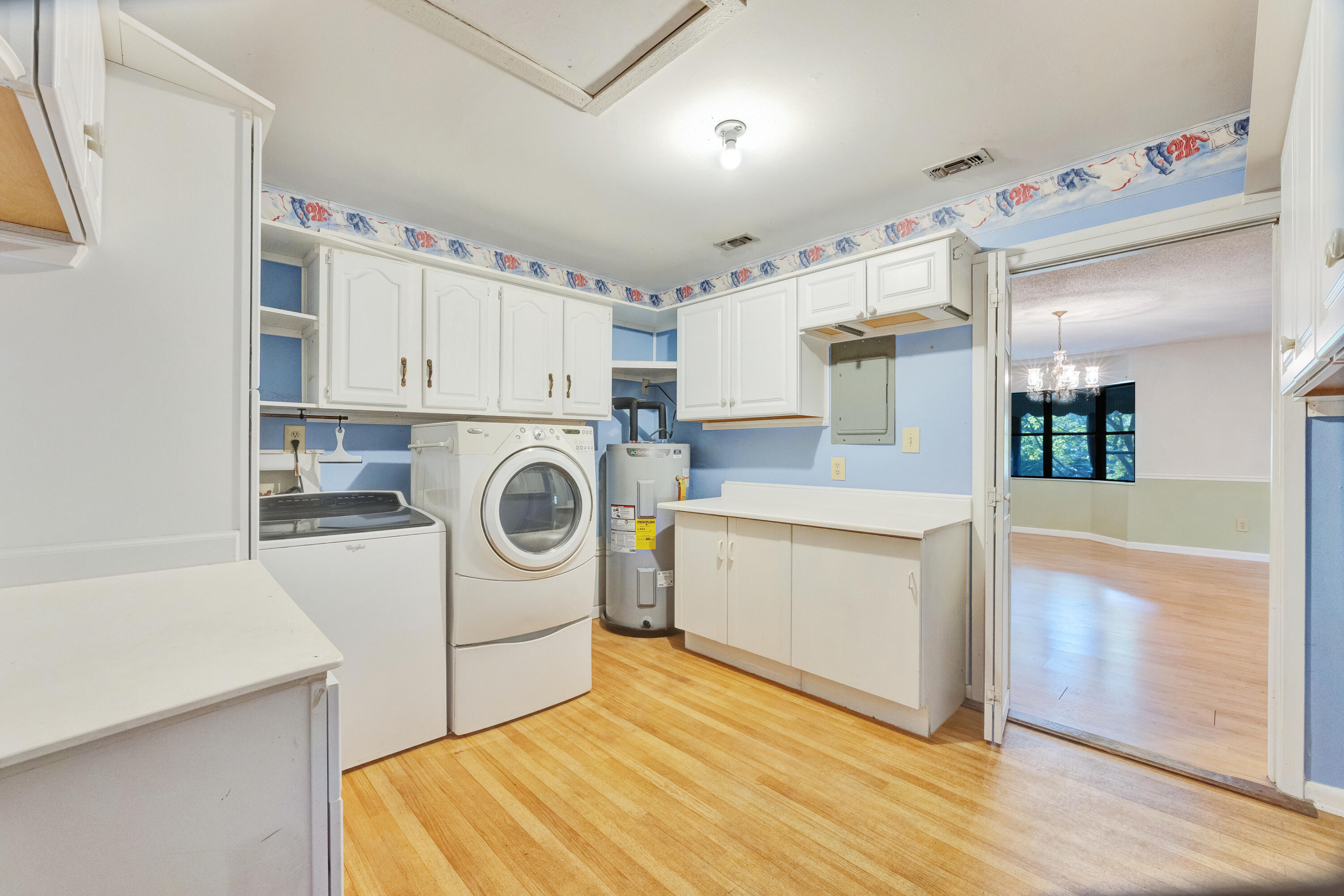 2540 Taylor Road Crestview, FL 32536 - Photo 33 of 75 a kitchen with cabinets a washer and dryer
