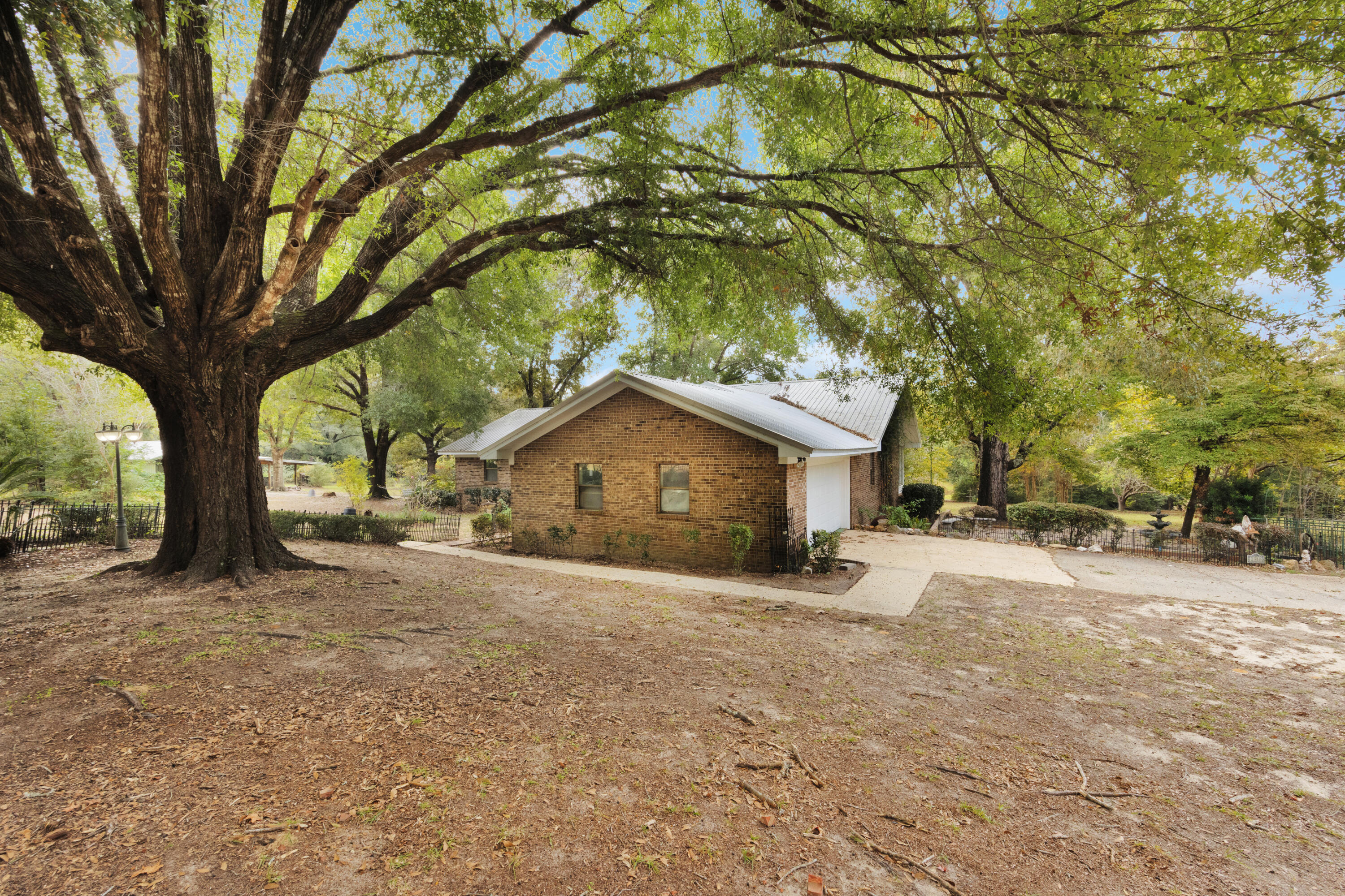 2540 Taylor Road Crestview, FL 32536 - Photo 4 of 75 a tall house with a large tree in front of it
