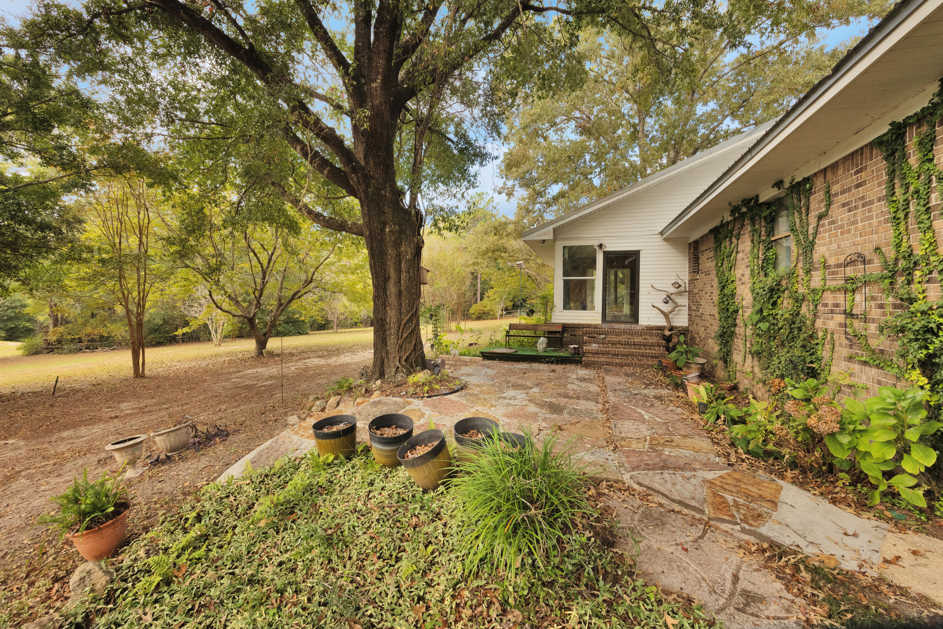 2540 Taylor Road Crestview, FL 32536 - Photo 47 of 75 a backyard of a house with table and chairs