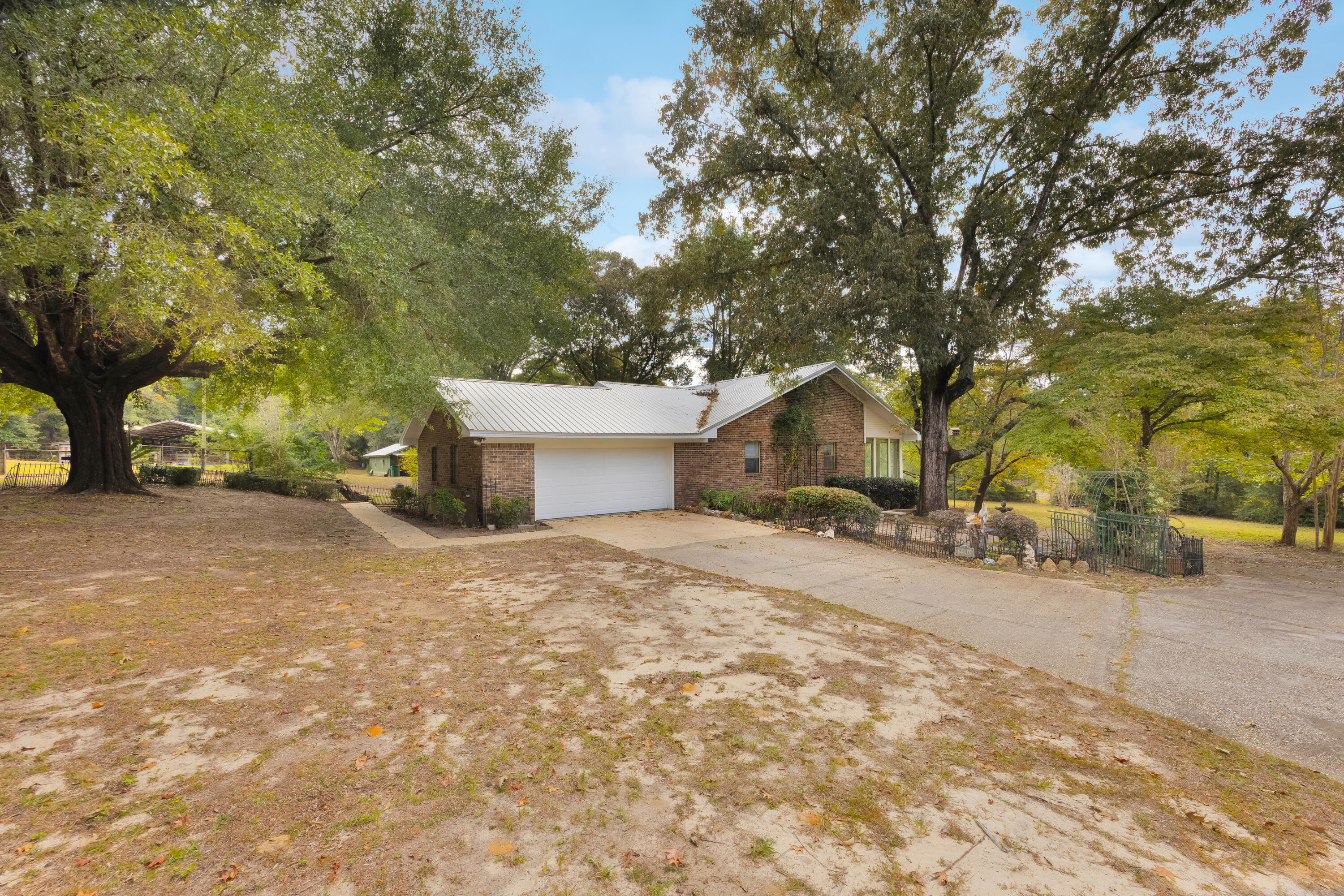 2540 Taylor Road Crestview, FL 32536 - Photo 5 of 75 a house with a yard and a large tree