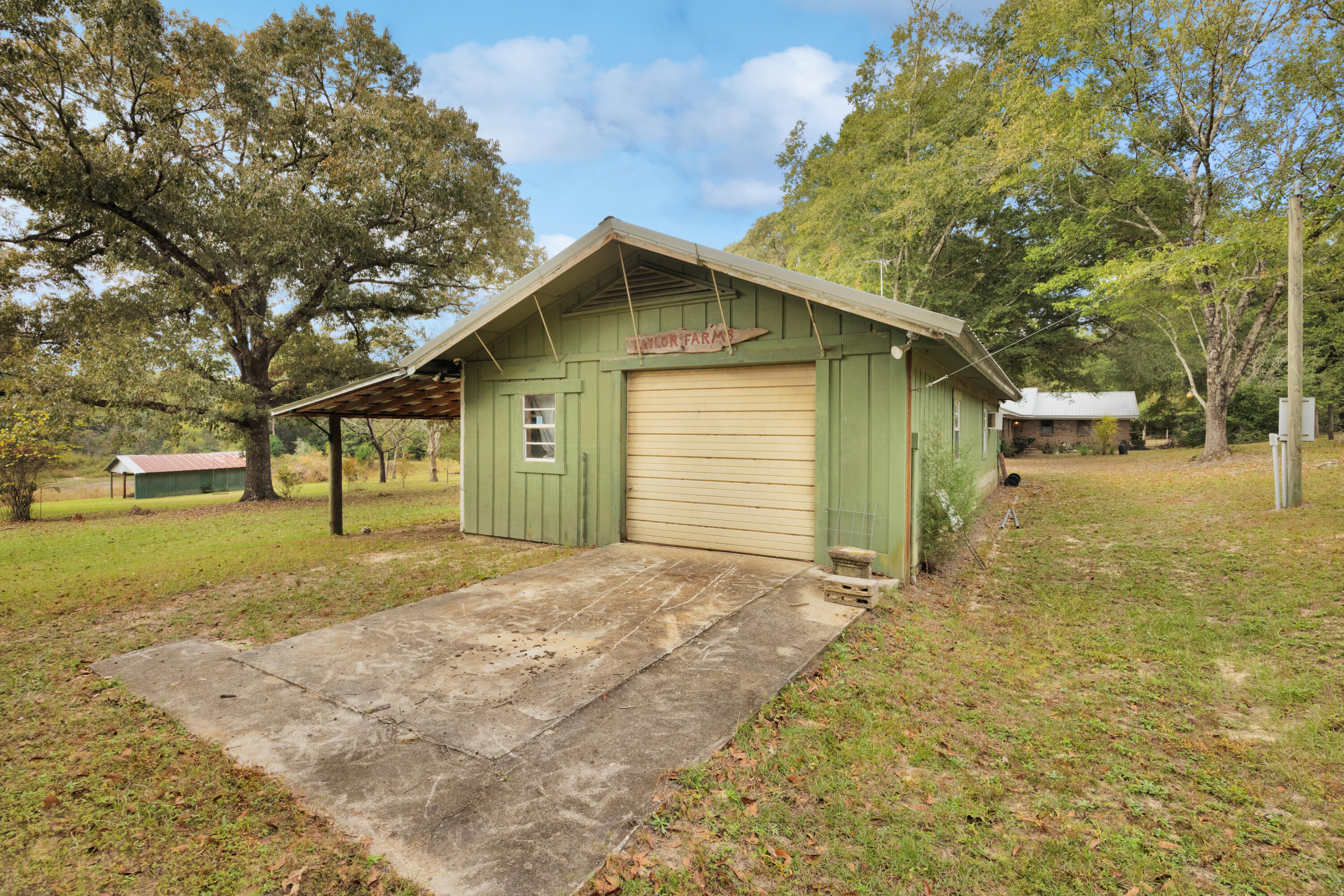 2540 Taylor Road Crestview, FL 32536 - Photo 52 of 75 a view of a house with a yard and garage