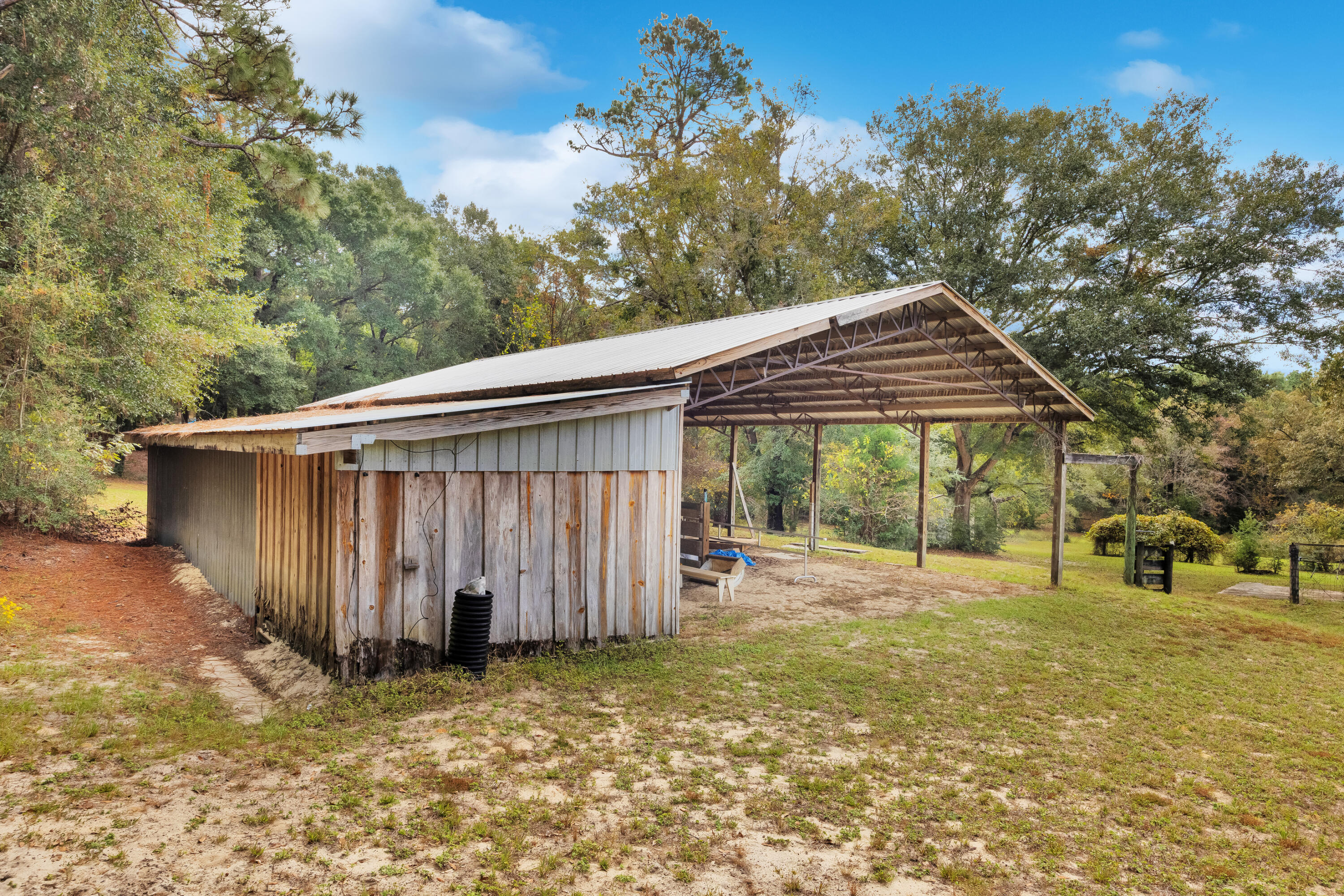 2540 Taylor Road Crestview, FL 32536 - Photo 59 of 75 a backyard of a house with barbeque oven table and chairs