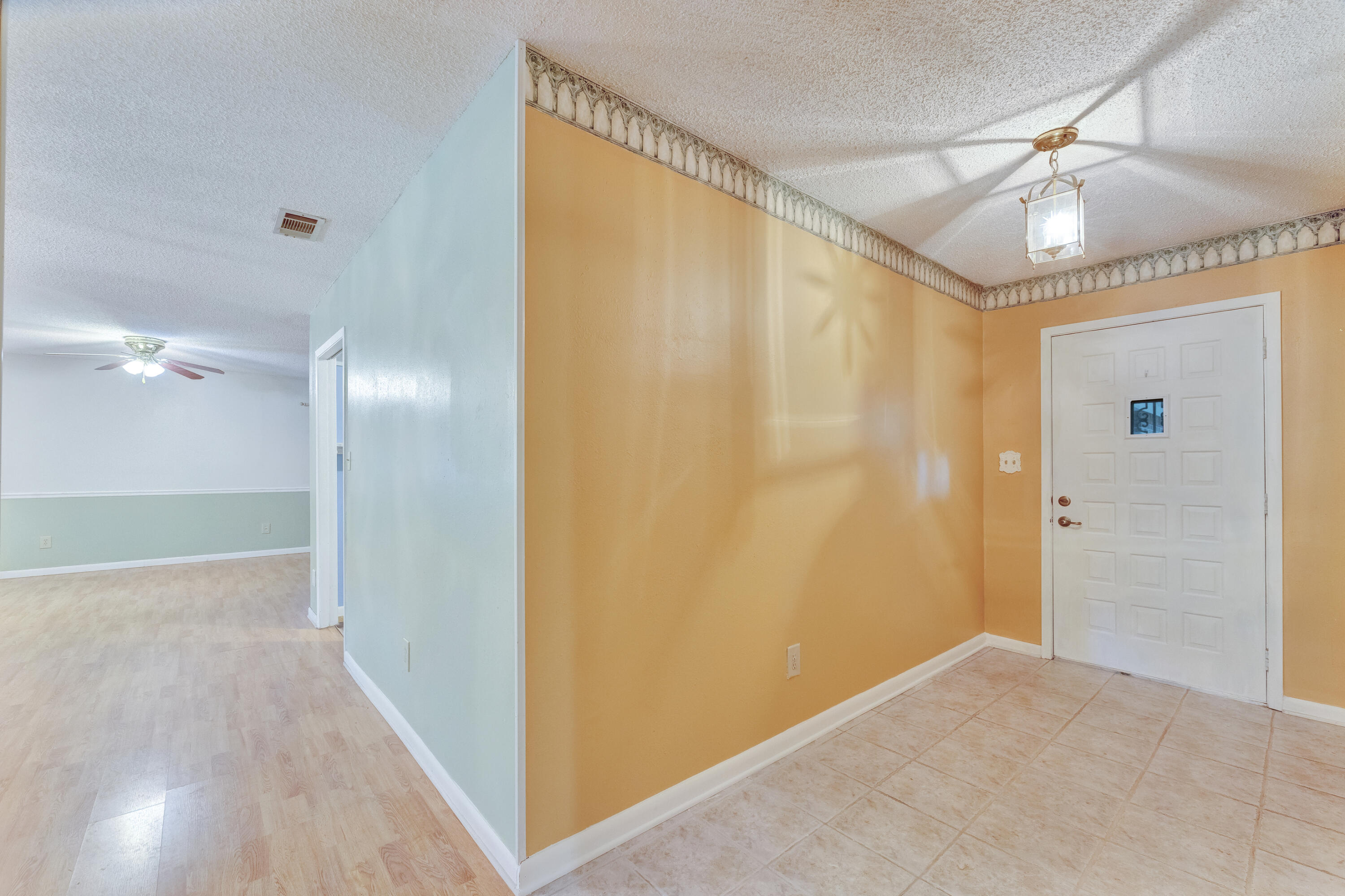 2540 Taylor Road Crestview, FL 32536 - Photo 7 of 75 a view of empty room with wooden floor and fan