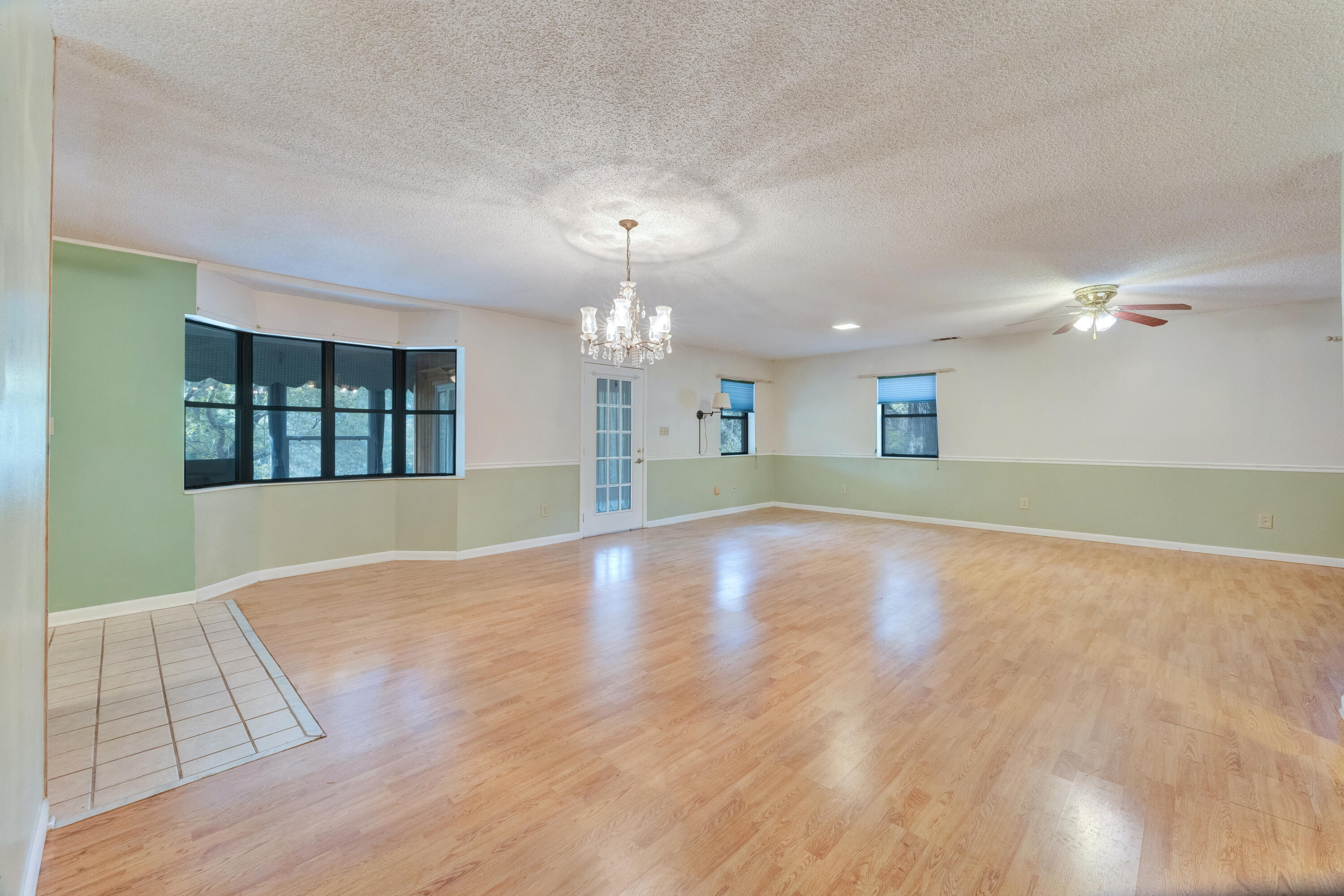 2540 Taylor Road Crestview, FL 32536 - Photo 8 of 75 a view of an empty room with window and wooden floor