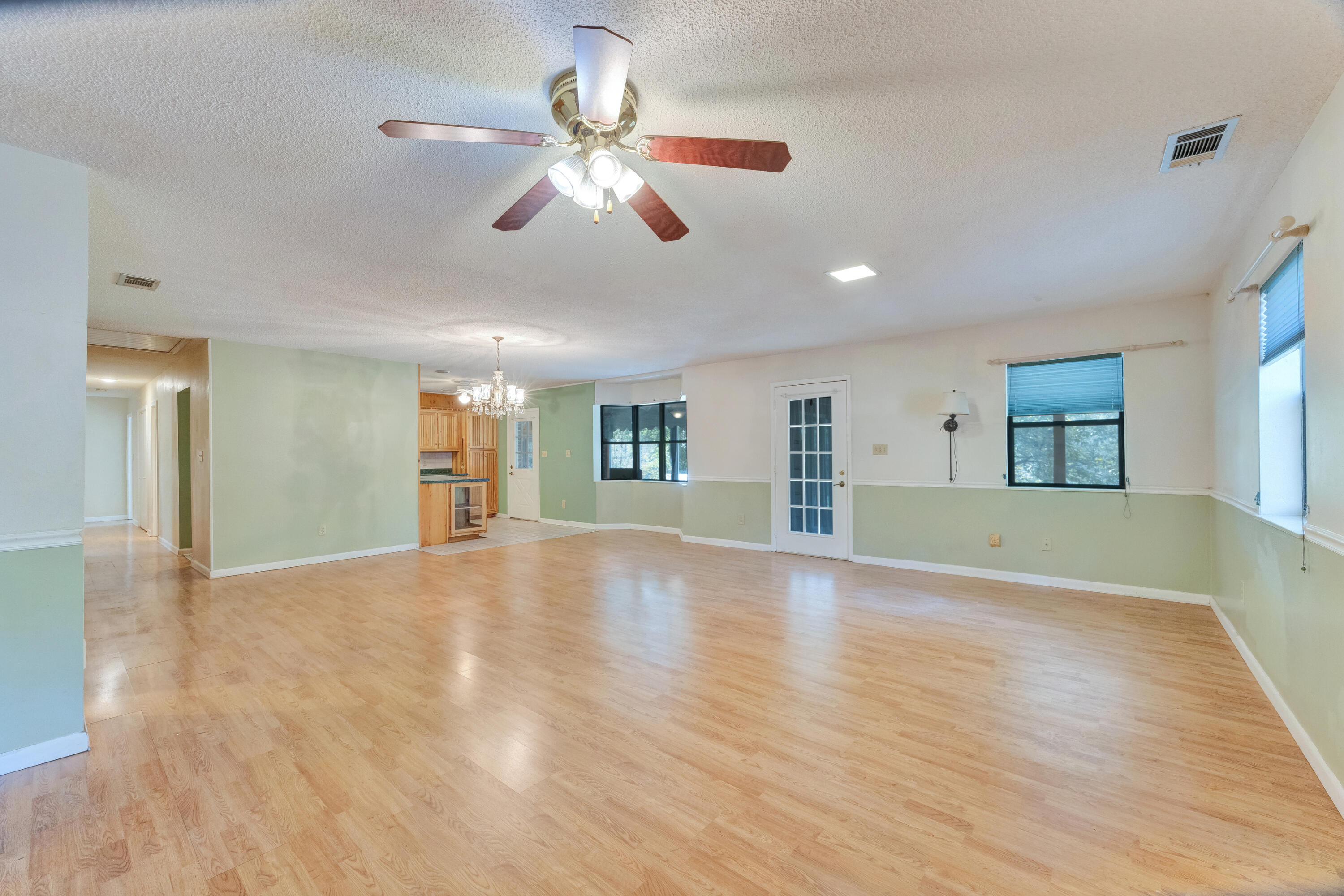 2540 Taylor Road Crestview, FL 32536 - Photo 10 of 75 a view of an empty room with window and wooden floor