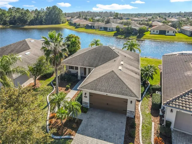 an aerial view of a house with outdoor space and lake view