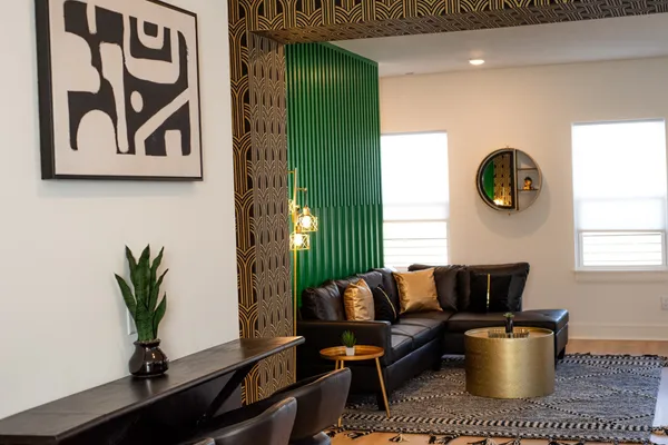 a living room with furniture and a potted plant