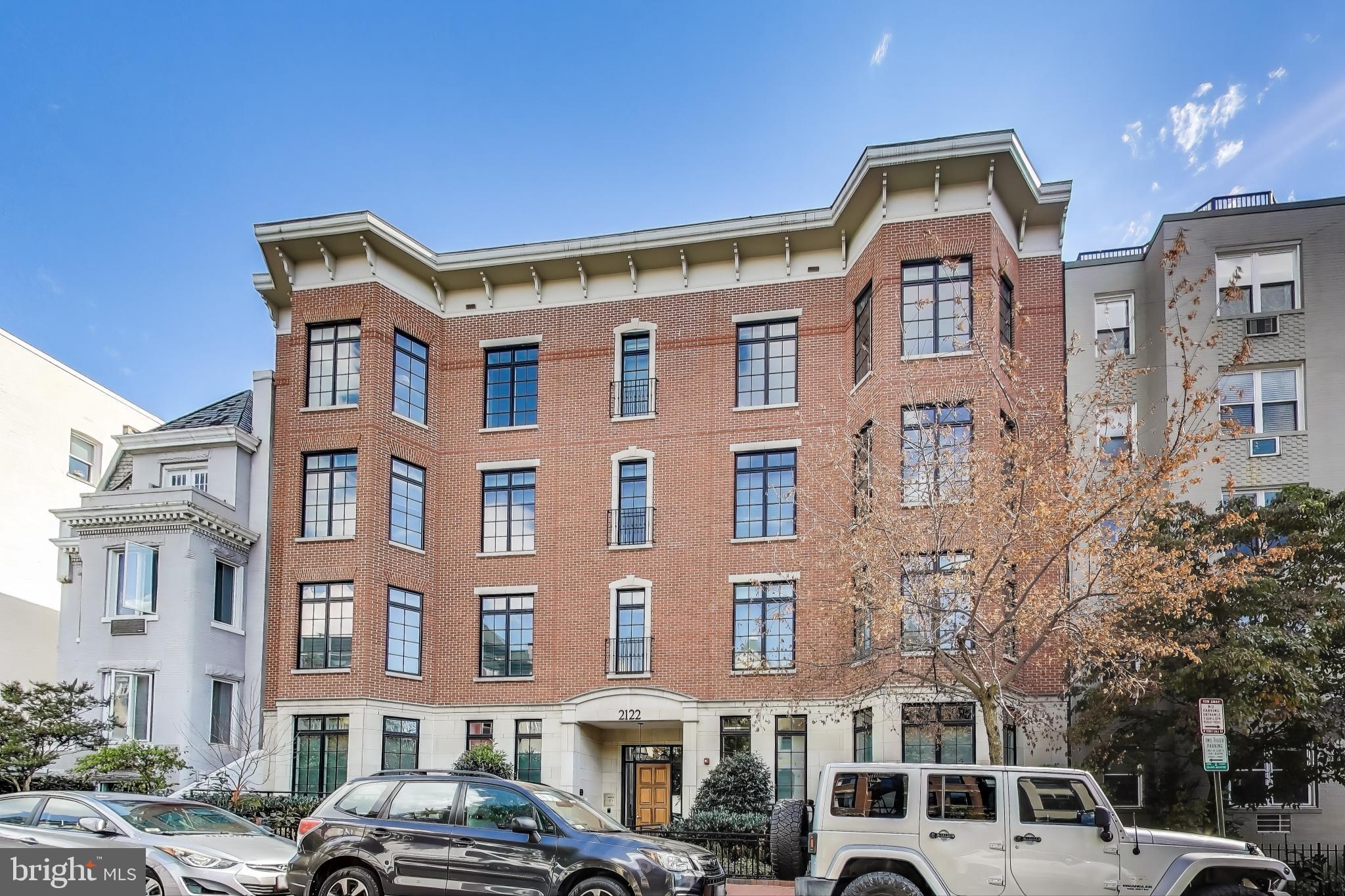 a front view of a residential apartment building with a yard