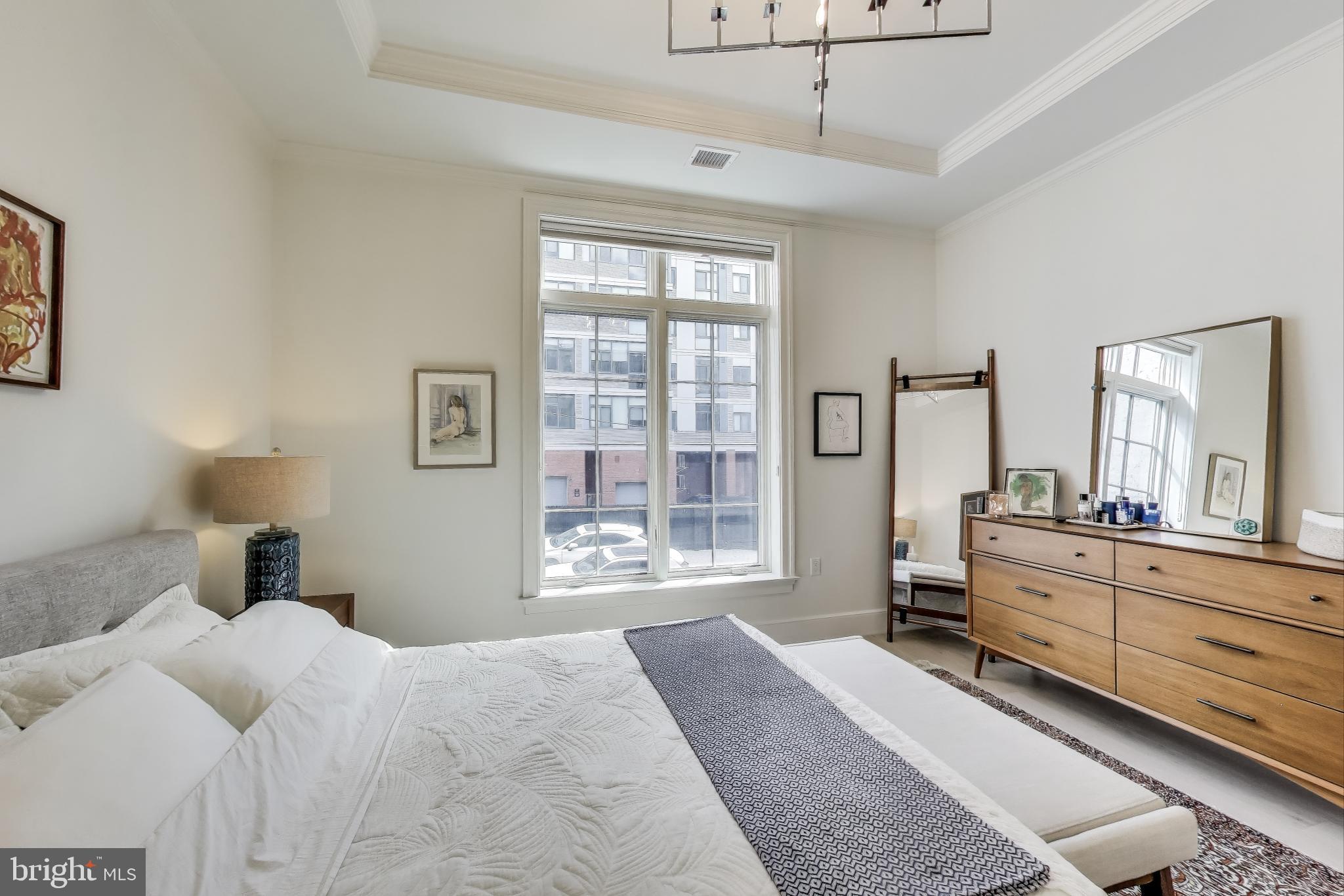 2122 N Street Northwest, Unit 5 Washington, DC 20037 - Photo 14 of 38 a bedroom with a large bed and a window