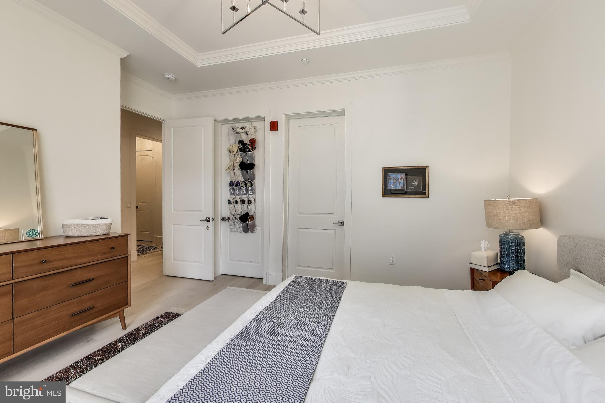 2122 N Street Northwest, Unit 5 Washington, DC 20037 - Photo 15 of 38 a bedroom with a bed and a dresser