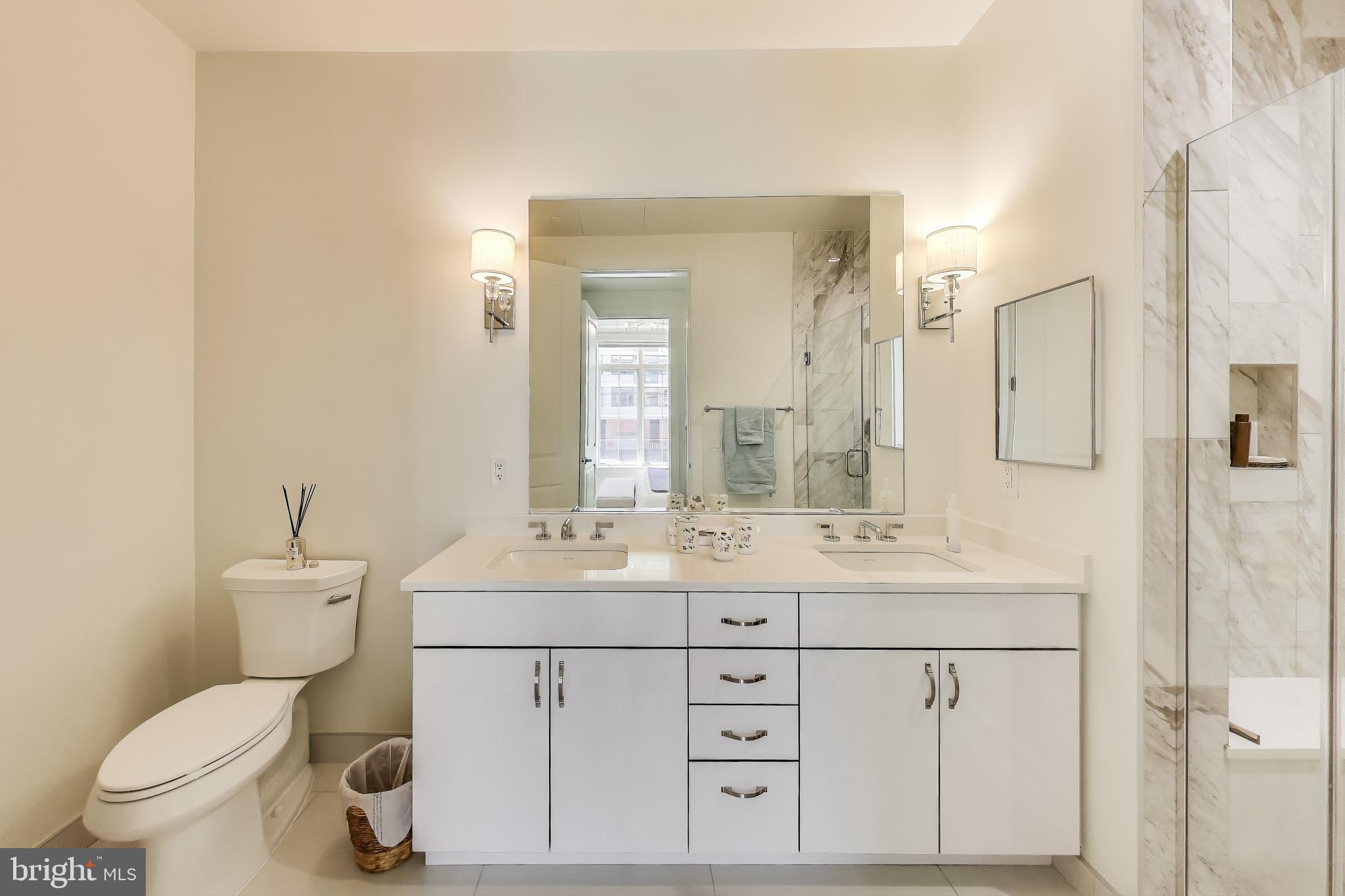 2122 N Street Northwest, Unit 5 Washington, DC 20037 - Photo 16 of 38 a bathroom with a sink toilet vanity and shower