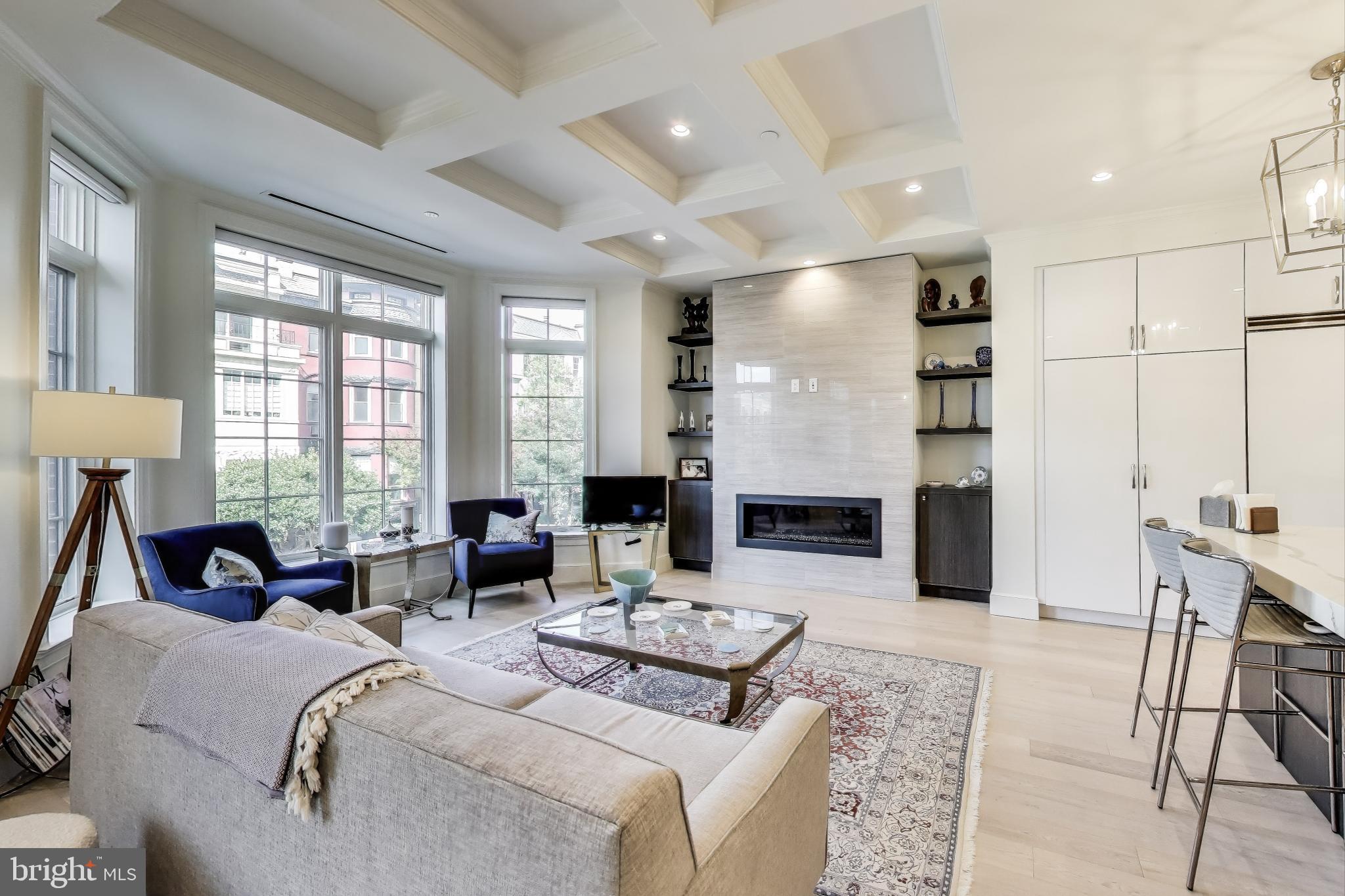 2122 N Street Northwest, Unit 5 Washington, DC 20037 - Photo 3 of 38 a living room with fireplace furniture and a large window