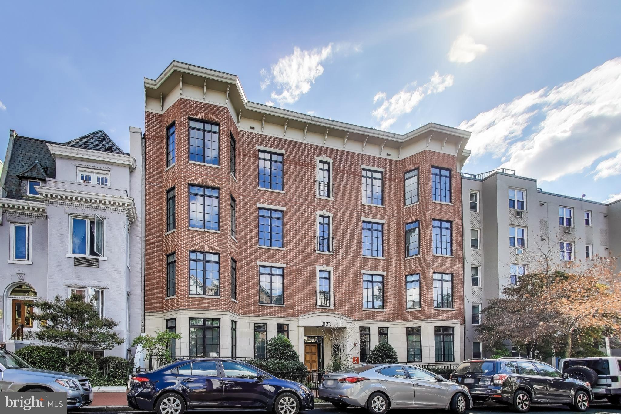 2122 N Street Northwest, Unit 5 Washington, DC 20037 - Photo 32 of 38 a front view of a building with lot of cars and trees