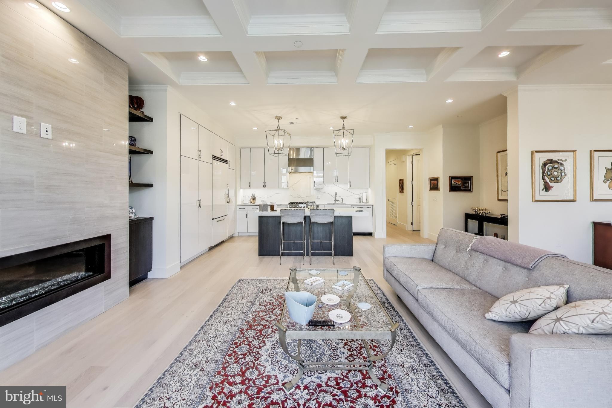 2122 N Street Northwest, Unit 5 Washington, DC 20037 - Photo 4 of 38 a large living room with furniture and a fireplace