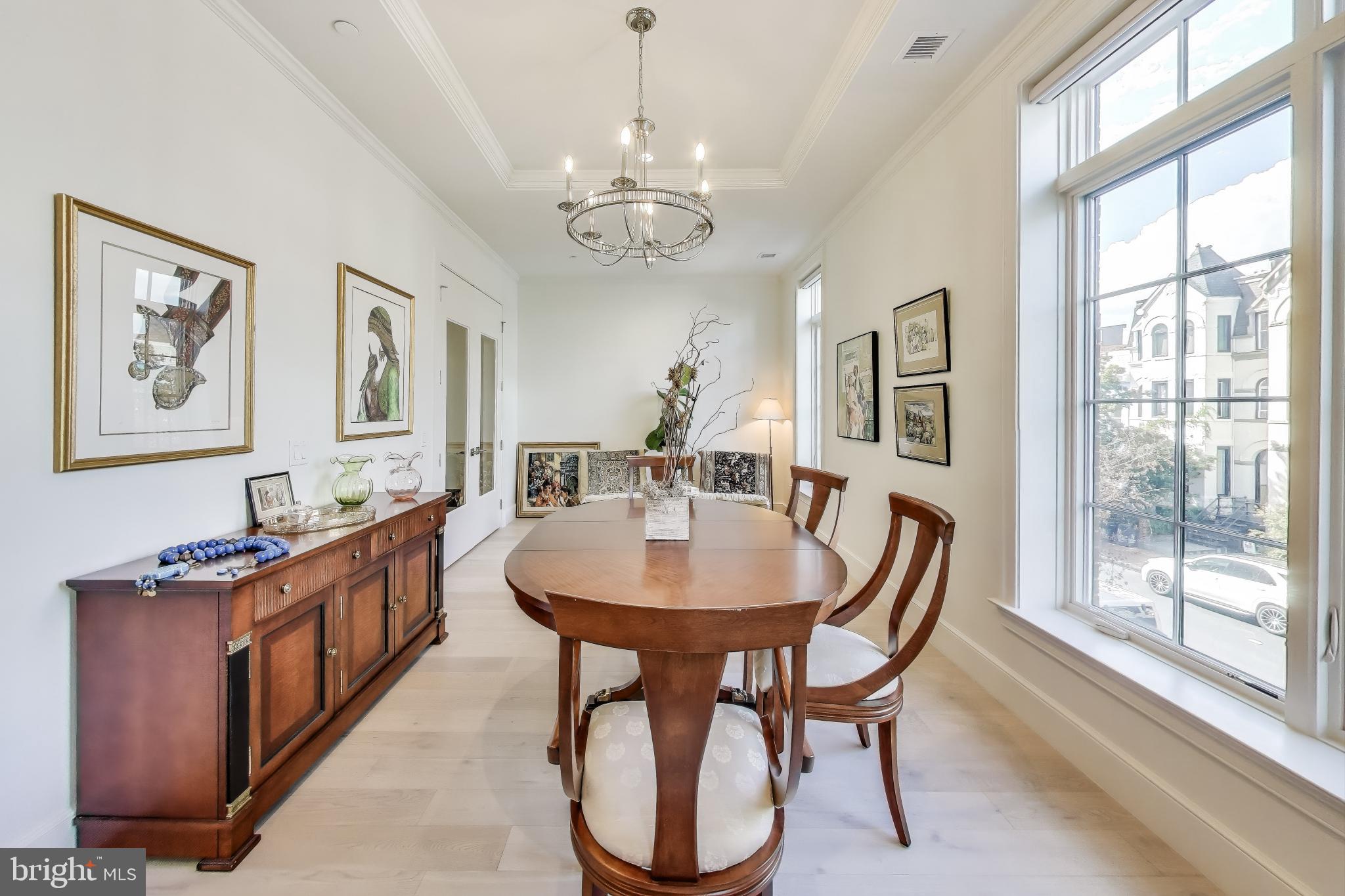 2122 N Street Northwest, Unit 5 Washington, DC 20037 - Photo 5 of 38 a dining room with chandelier and wooden floor