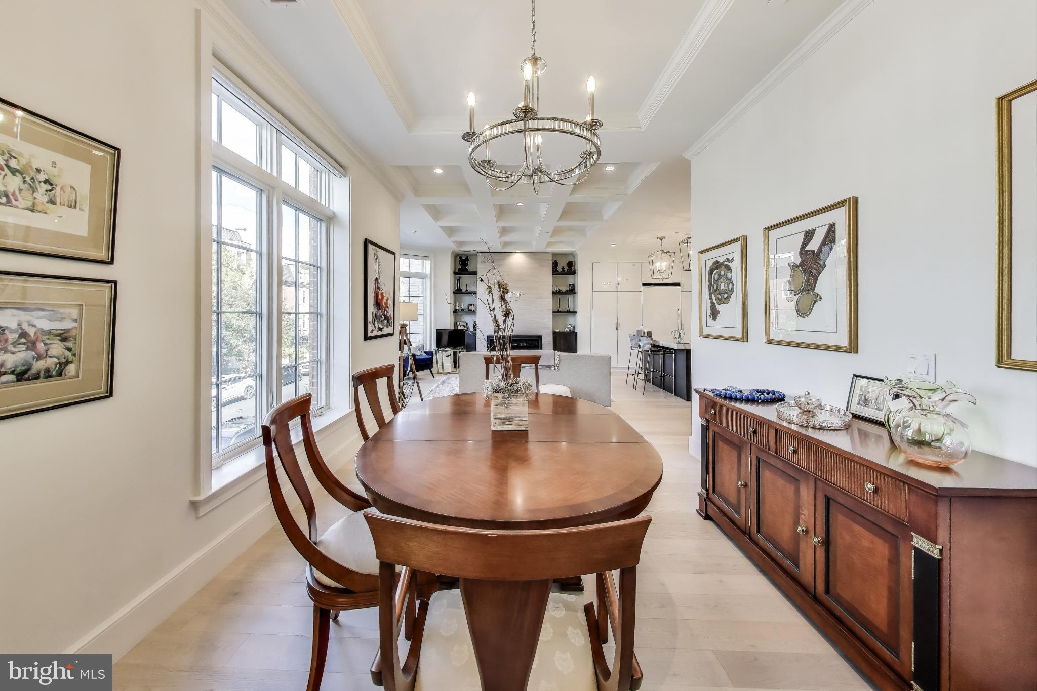 2122 N Street Northwest, Unit 5 Washington, DC 20037 - Photo 6 of 38 a dining room with wooden floor a chandelier a wooden table and chairs