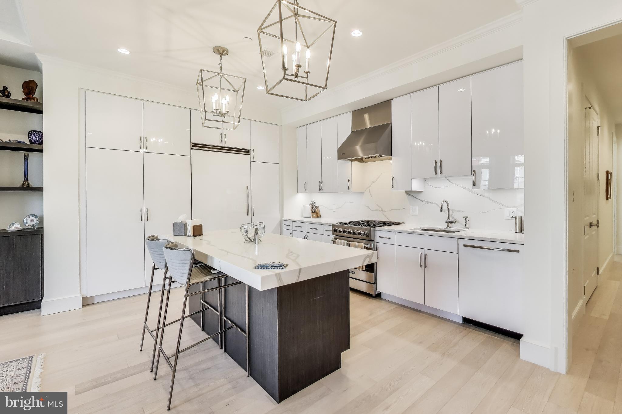 2122 N Street Northwest, Unit 5 Washington, DC 20037 - Photo 7 of 38 a kitchen with sink stove and white cabinets
