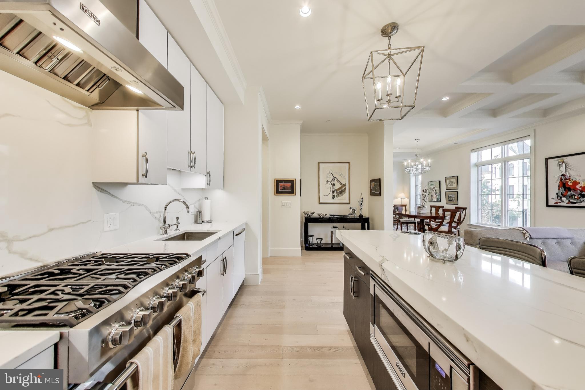 2122 N Street Northwest, Unit 5 Washington, DC 20037 - Photo 9 of 38 a kitchen with stainless steel appliances a sink a stove and cabinets