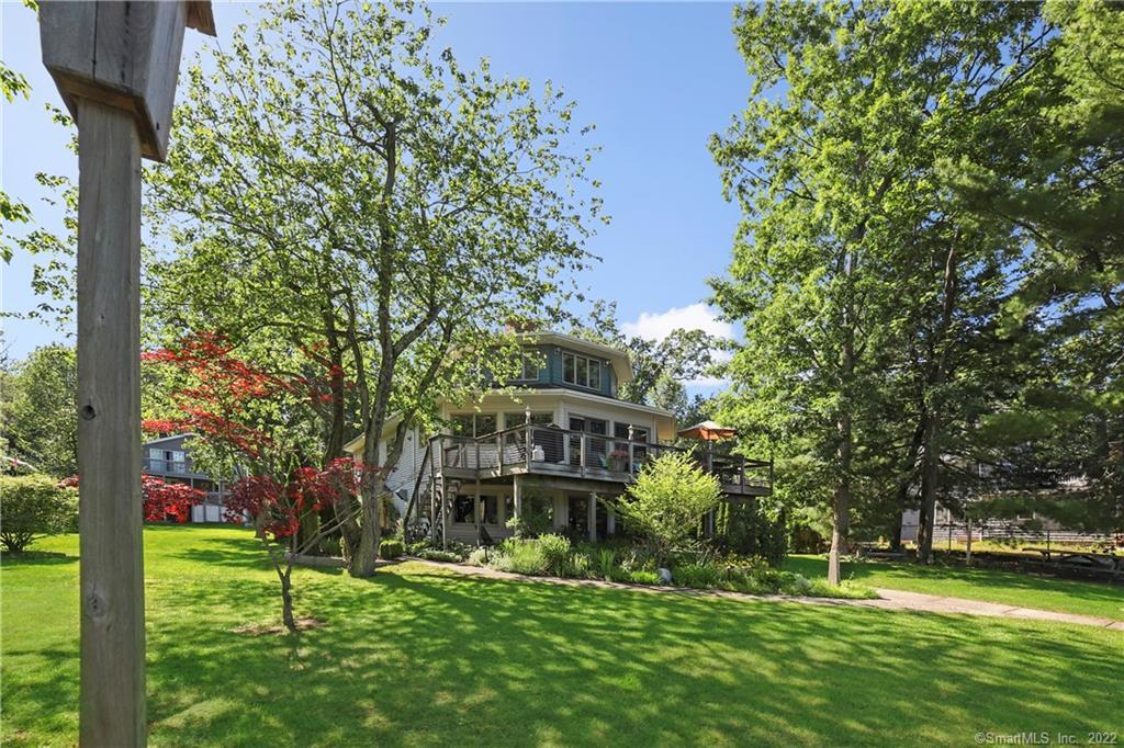 a view of a big building with a big yard and large trees