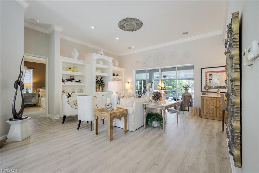 8475 Gleneagle Way Naples, FL 34120 - Photo 11 of 46 a living room with furniture and a wooden floor