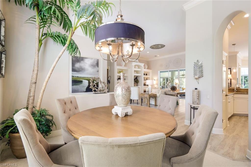 8475 Gleneagle Way Naples, FL 34120 - Photo 14 of 46 a dining room with furniture and wooden floor