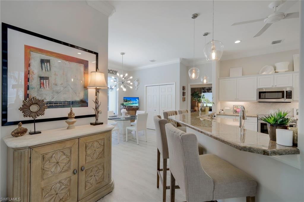 8475 Gleneagle Way Naples, FL 34120 - Photo 15 of 46 a large kitchen with lots of counter space and painting on the wall